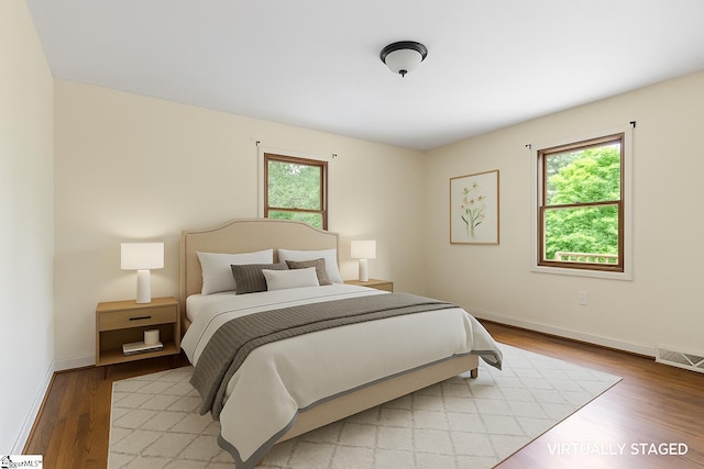 bedroom featuring light wood-type flooring and baseboards