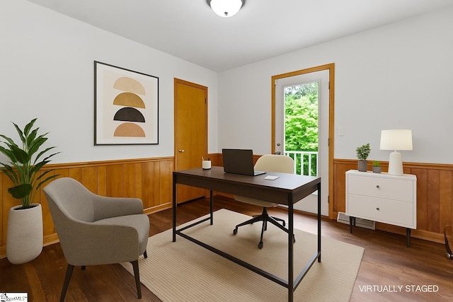 office with wainscoting, wood finished floors, and wooden walls