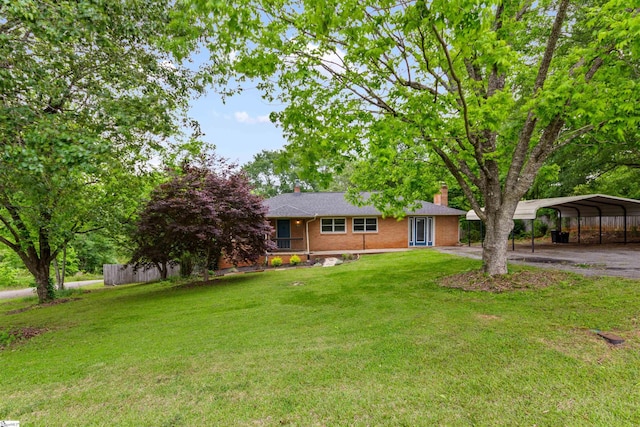 ranch-style house with a chimney, asphalt driveway, a carport, and brick siding