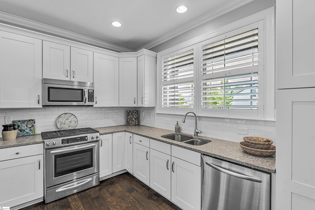 302 Owasso Dr, Greenville, SC 29615 - kitchen with appliances with stainless steel finishes, a sink, ornamental molding, white cabinetry, and dark wood-type flooring