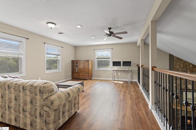 21 Pebble Creek Way, Taylors, SC 29687 - living area featuring wood finished floors, plenty of natural light, a ceiling fan, beam ceiling, and a textured ceiling