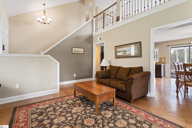 21 Pebble Creek Way, Taylors, SC 29687 - living area featuring a chandelier, wood finished floors, baseboards, and a towering ceiling