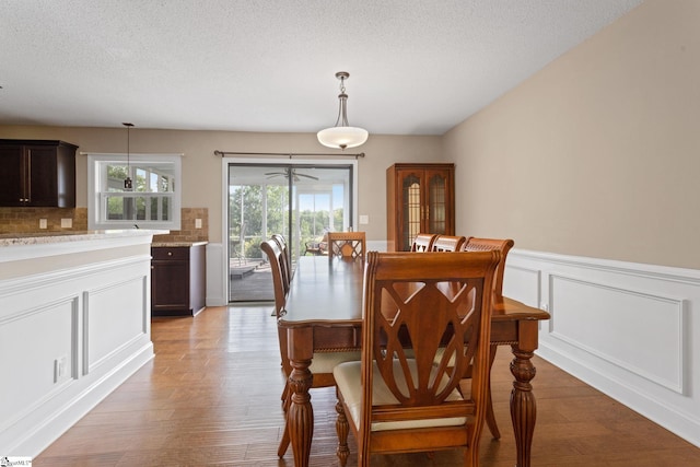 21 Pebble Creek Way, Taylors, SC 29687 - dining area with light wood-type flooring, wainscoting, and a textured ceiling