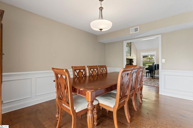 21 Pebble Creek Way, Taylors, SC 29687 - dining space with wood finished floors, a wainscoted wall, and a decorative wall