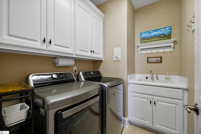 clothes washing area featuring washing machine and dryer and cabinet space