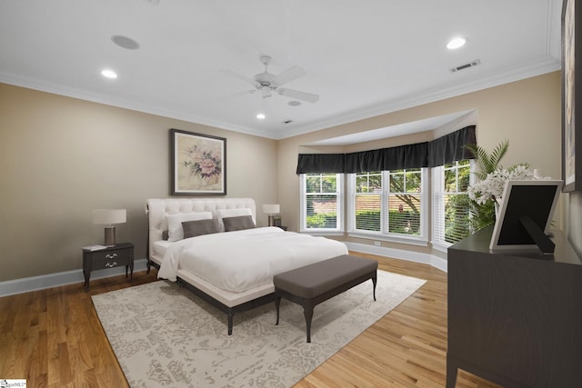 bedroom featuring baseboards, recessed lighting, ornamental molding, light wood-style flooring, and ceiling fan
