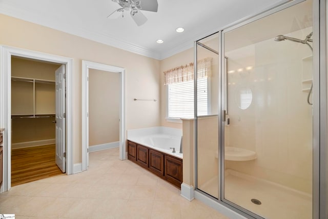 bathroom with ornamental molding, ceiling fan, a garden tub, a shower stall, and tile patterned floors