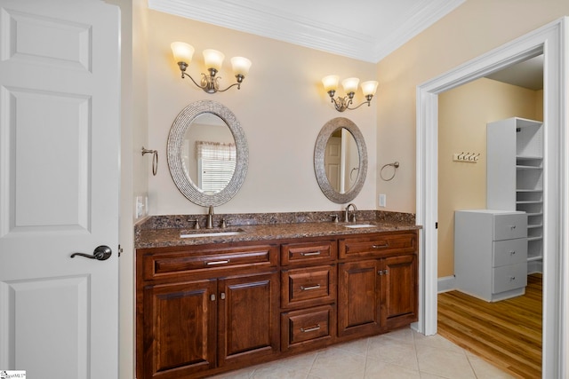 bathroom featuring ornamental molding and double vanity