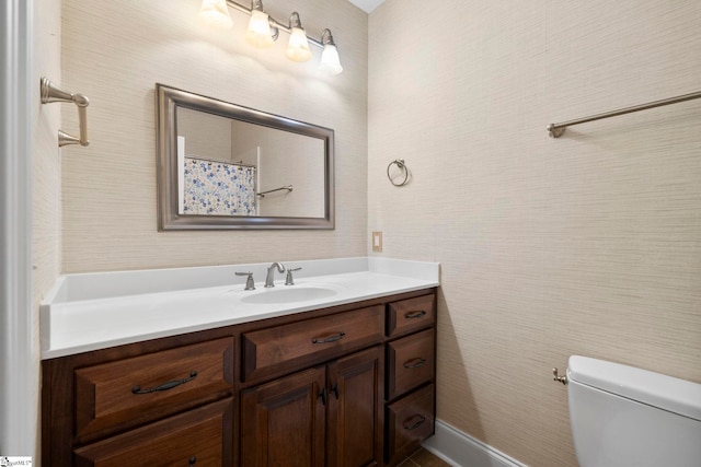 bathroom with toilet and vanity