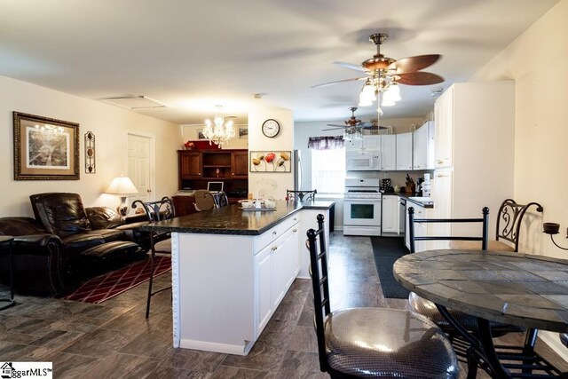521 N Calhoun Shores Pkwy, Calhoun Falls, SC 29628 - kitchen featuring white appliances, dark countertops, white cabinets, a kitchen bar, and a ceiling fan