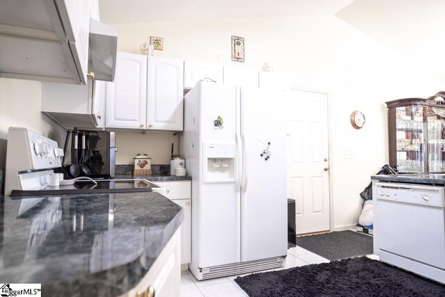 521 N Calhoun Shores Pkwy, Calhoun Falls, SC 29628 - kitchen featuring white appliances, vaulted ceiling, white cabinets, light tile patterned floors, and wall chimney range hood