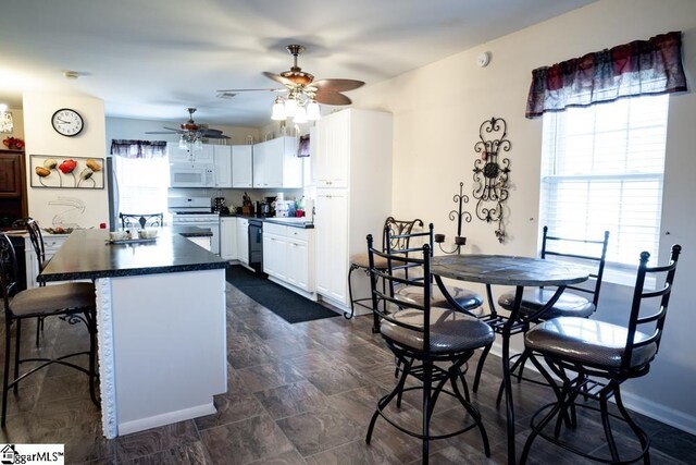 521 N Calhoun Shores Pkwy, Calhoun Falls, SC 29628 - kitchen featuring white appliances, ceiling fan, white cabinetry, and plenty of natural light