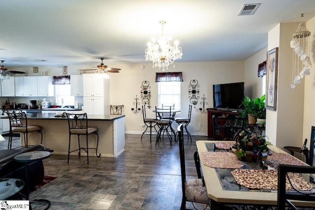 521 N Calhoun Shores Pkwy, Calhoun Falls, SC 29628 - dining area featuring a ceiling fan, baseboards, and a chandelier