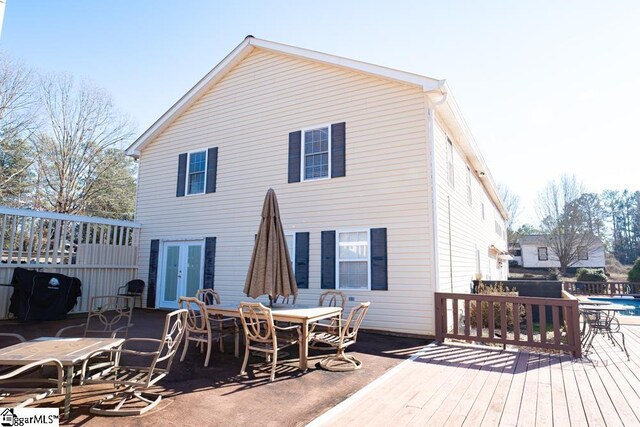 521 N Calhoun Shores Pkwy, Calhoun Falls, SC 29628 - rear view of house featuring french doors, a deck, an outdoor pool, and outdoor dining space