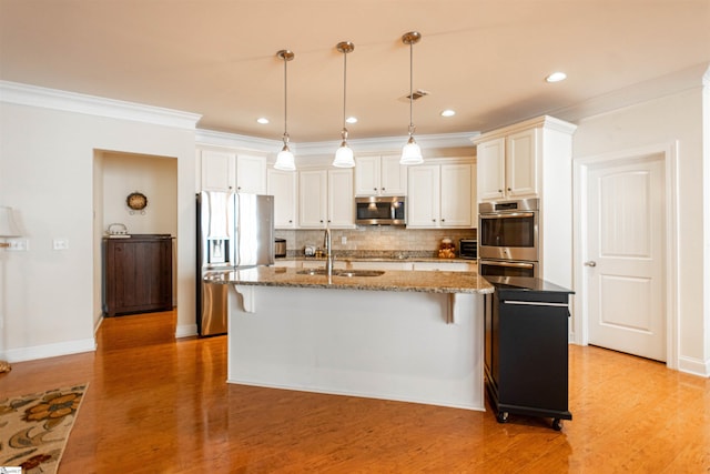 30 Kittery Dr, Greenville, SC 29615 - kitchen featuring stainless steel appliances, a sink, decorative backsplash, a breakfast bar, and light stone countertops