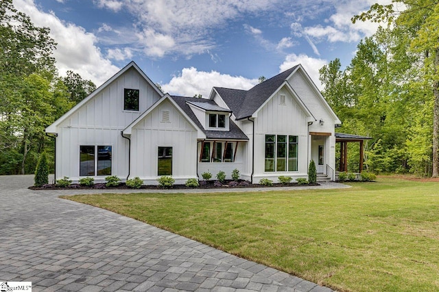 205 Fairview Dr, Greenville, SC 29609 - modern farmhouse with board and batten siding, a front lawn, covered porch, and a shingled roof