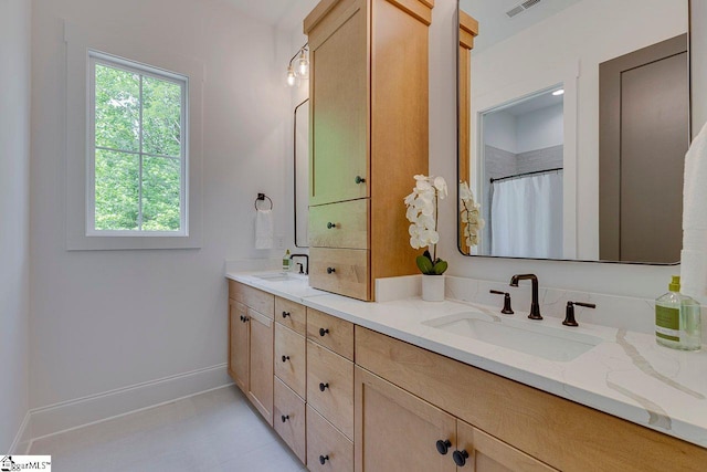 205 Fairview Dr, Greenville, SC 29609 - bathroom with double vanity and baseboards