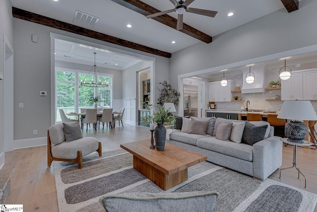 205 Fairview Dr, Greenville, SC 29609 - living area featuring beam ceiling, ceiling fan, light wood-style flooring, recessed lighting, and a chandelier