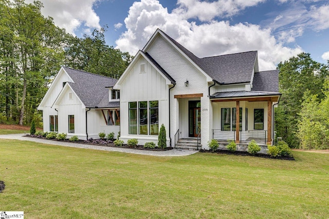 205 Fairview Dr, Greenville, SC 29609 - modern inspired farmhouse featuring board and batten siding, roof with shingles, a front yard, and a porch