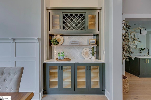 205 Fairview Dr, Greenville, SC 29609 - detailed view of decorative backsplash, wood finished floors, and a sink