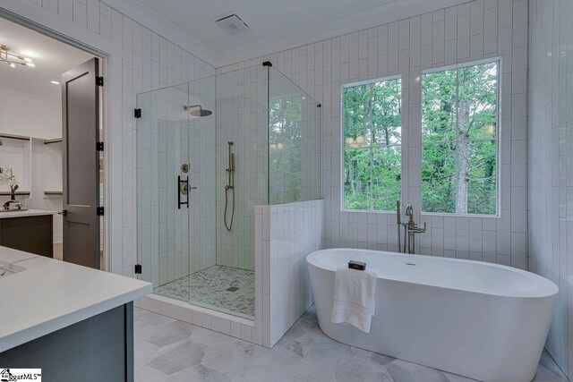 205 Fairview Dr, Greenville, SC 29609 - bathroom with vanity, a shower stall, a freestanding bath, and healthy amount of natural light
