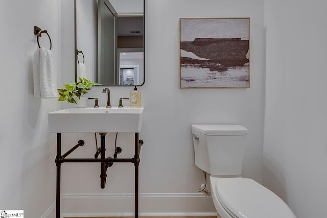 205 Fairview Dr, Greenville, SC 29609 - bathroom featuring toilet, a sink, and baseboards