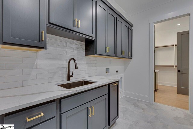 205 Fairview Dr, Greenville, SC 29609 - kitchen with a sink, light stone counters, backsplash, gray cabinets, and baseboards