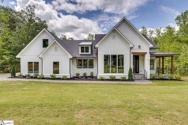 205 Fairview Dr, Greenville, SC 29609 - modern farmhouse featuring board and batten siding, a front lawn, a standing seam roof, a shingled roof, and a porch