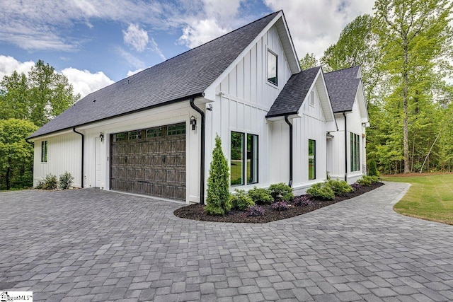 205 Fairview Dr, Greenville, SC 29609 - view of home's exterior featuring an attached garage, board and batten siding, decorative driveway, and a shingled roof