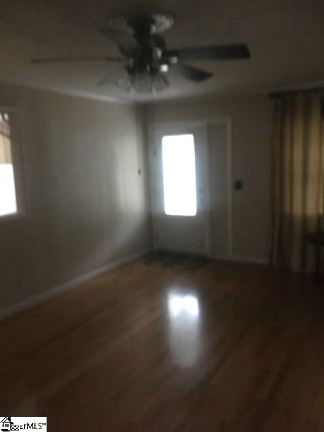 413 S Florida Ave, Greenville, SC 29611 - empty room with ceiling fan, wood finished floors, and baseboards