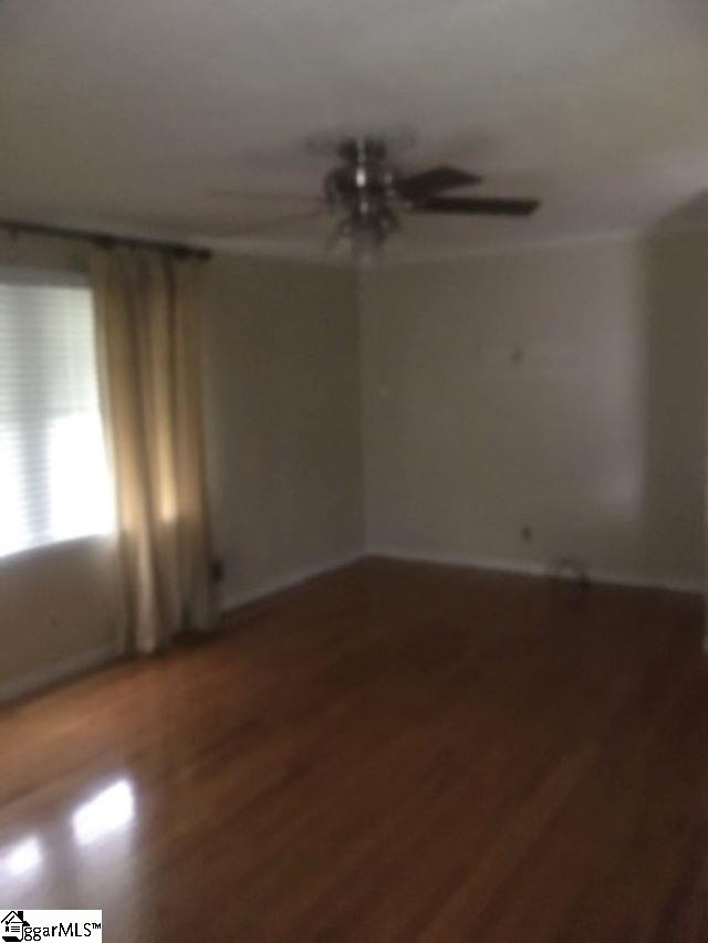 413 S Florida Ave, Greenville, SC 29611 - empty room featuring wood finished floors, ceiling fan, and baseboards