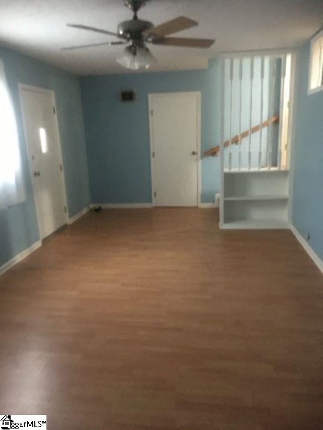 413 S Florida Ave, Greenville, SC 29611 - unfurnished living room with a ceiling fan, baseboards, and wood finished floors