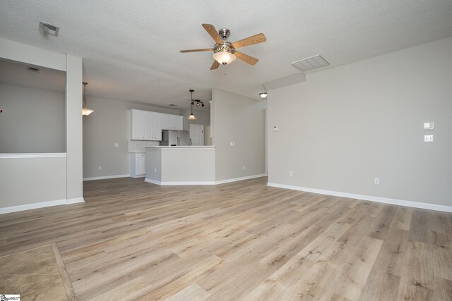 300 Stillwater Ct, Simpsonville, SC 29681 - unfurnished living room with ceiling fan, light wood-type flooring, baseboards, and a textured ceiling