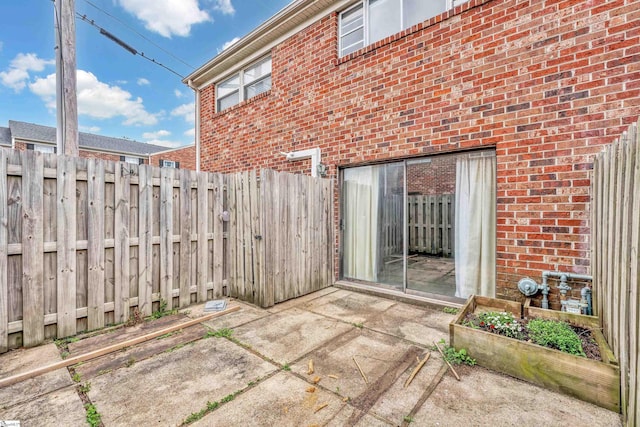 2530 E N St Unit 13K, Greenville, SC 29615 - view of patio / terrace featuring fence and a vegetable garden