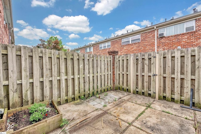 2530 E N St Unit 13K, Greenville, SC 29615 - view of patio featuring fence and a vegetable garden