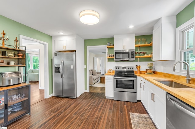 101 Kenilworth Ct, Greenville, SC 29615 - kitchen featuring appliances with stainless steel finishes, open shelves, a sink, dark wood finished floors, and white cabinetry