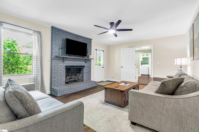 101 Kenilworth Ct, Greenville, SC 29615 - living area featuring washer / dryer, wood finished floors, a fireplace, ceiling fan, and baseboards