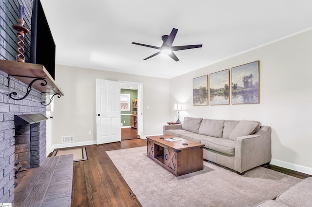 101 Kenilworth Ct, Greenville, SC 29615 - living room featuring a brick fireplace, dark wood-style floors, ceiling fan, and baseboards