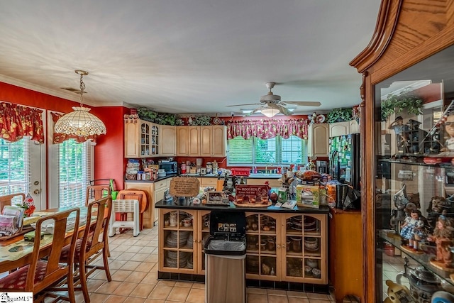 818 S Almond Dr, Simpsonville, SC 29681 - kitchen featuring dark countertops, glass insert cabinets, ceiling fan, light tile patterned floors, and pendant lighting