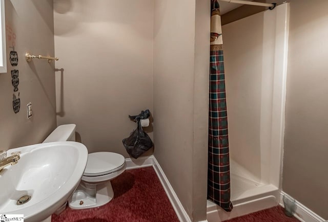 818 S Almond Dr, Simpsonville, SC 29681 - bathroom featuring a shower stall, a sink, toilet, and baseboards