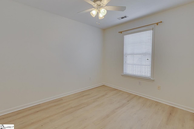 unfurnished room featuring wood finished floors, baseboards, and a ceiling fan