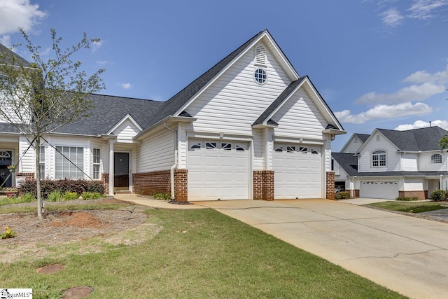 view of front of house with brick siding, concrete driveway, a front lawn, and a shingled roof