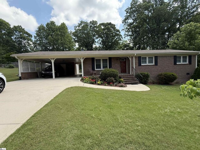10 Dickens Ln, Taylors, SC 29687 - single story home with concrete driveway, brick siding, a front yard, and an attached carport