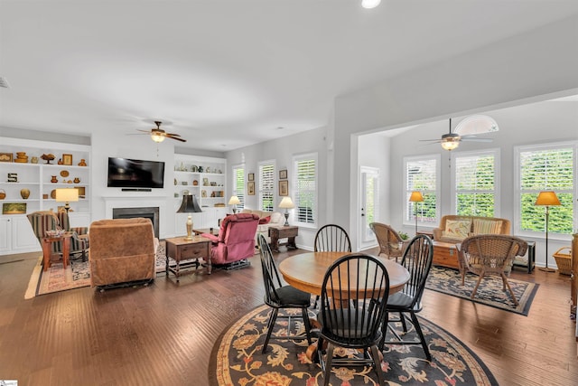 708 Emerald Hill Ct, Simpsonville, SC 29681 - dining area with ceiling fan, dark wood-style flooring, a fireplace, built in shelves, and recessed lighting