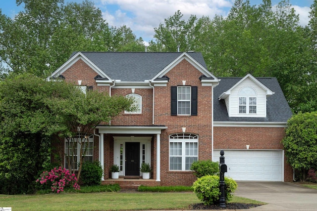 104 White Bark Way, Taylors, SC 29687 - georgian-style home with brick siding, driveway, a garage, and roof with shingles