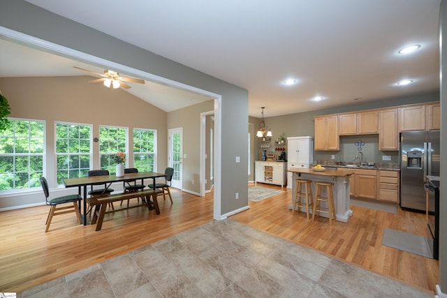 104 White Bark Way, Taylors, SC 29687 - kitchen with stainless steel fridge with ice dispenser, a sink, a center island, light wood-style flooring, and light brown cabinetry