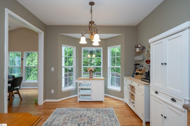 104 White Bark Way, Taylors, SC 29687 - kitchen featuring open shelves, a chandelier, light wood-type flooring, and decorative light fixtures