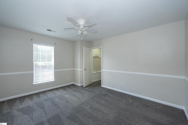 104 White Bark Way, Taylors, SC 29687 - spare room featuring ceiling fan, baseboards, and dark colored carpet