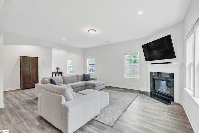 153 Coppermine Dr, Easley, SC 29642 - living room with a glass covered fireplace, wood finished floors, arched walkways, baseboards, and recessed lighting