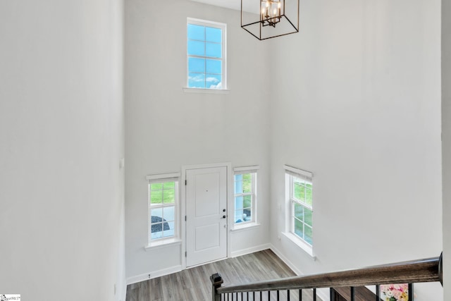 153 Coppermine Dr, Easley, SC 29642 - foyer featuring a chandelier, a high ceiling, healthy amount of natural light, wood finished floors, and baseboards